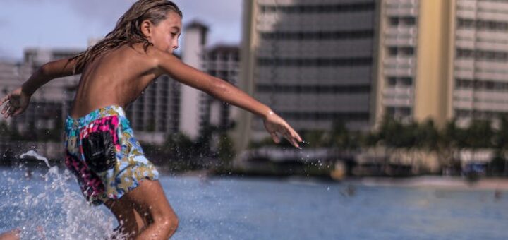 boy practicing in surfing on seawater